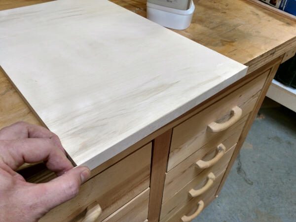 holding the other side of veneer flush on shelf edge