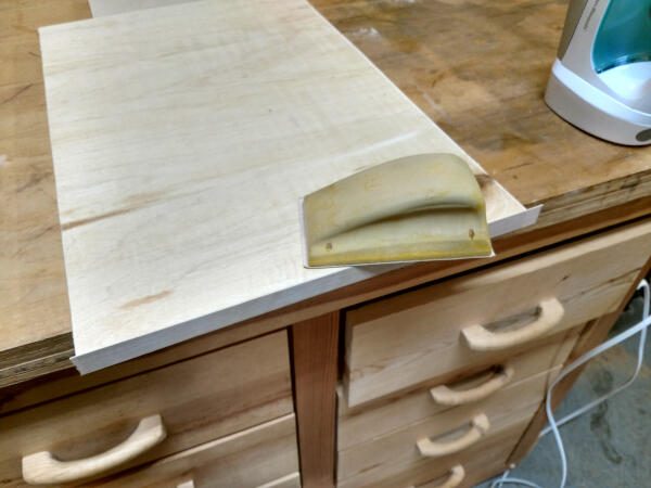 sanding the veneer edging to the shelf